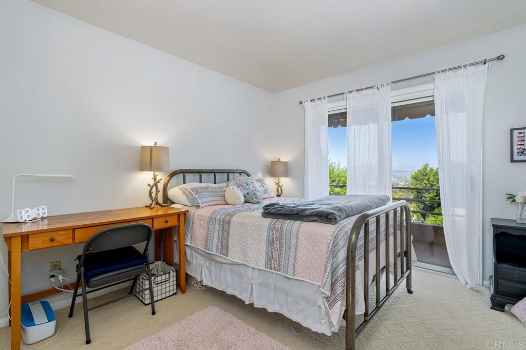 1239 Jamacha Road El Cajon, CA 92019 - Photo 15 of 24 a bedroom with a bed and a table