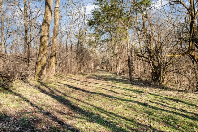 a view of empty space with wooden fence