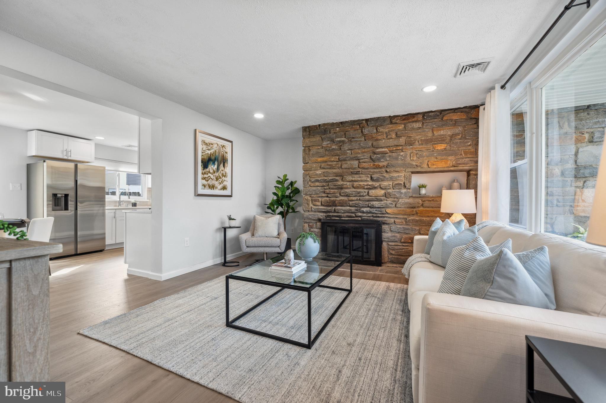 2210 Sproul Road Broomall, PA 19008 - Photo 11 of 26 a living room with furniture and a fireplace