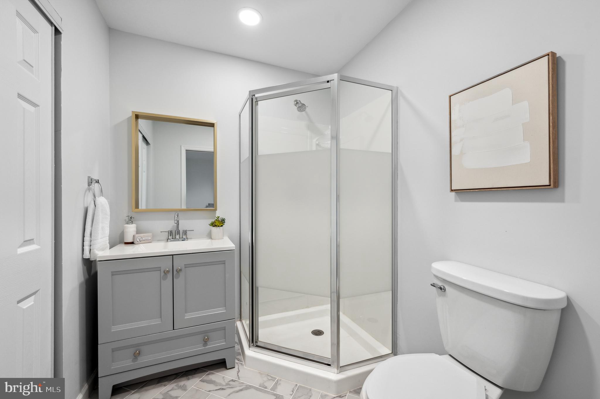 2210 Sproul Road Broomall, PA 19008 - Photo 16 of 26 a bathroom with a toilet sink shower and mirror