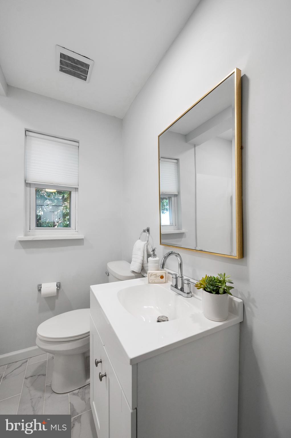 2210 Sproul Road Broomall, PA 19008 - Photo 23 of 26 a bathroom with a toilet a sink and mirror