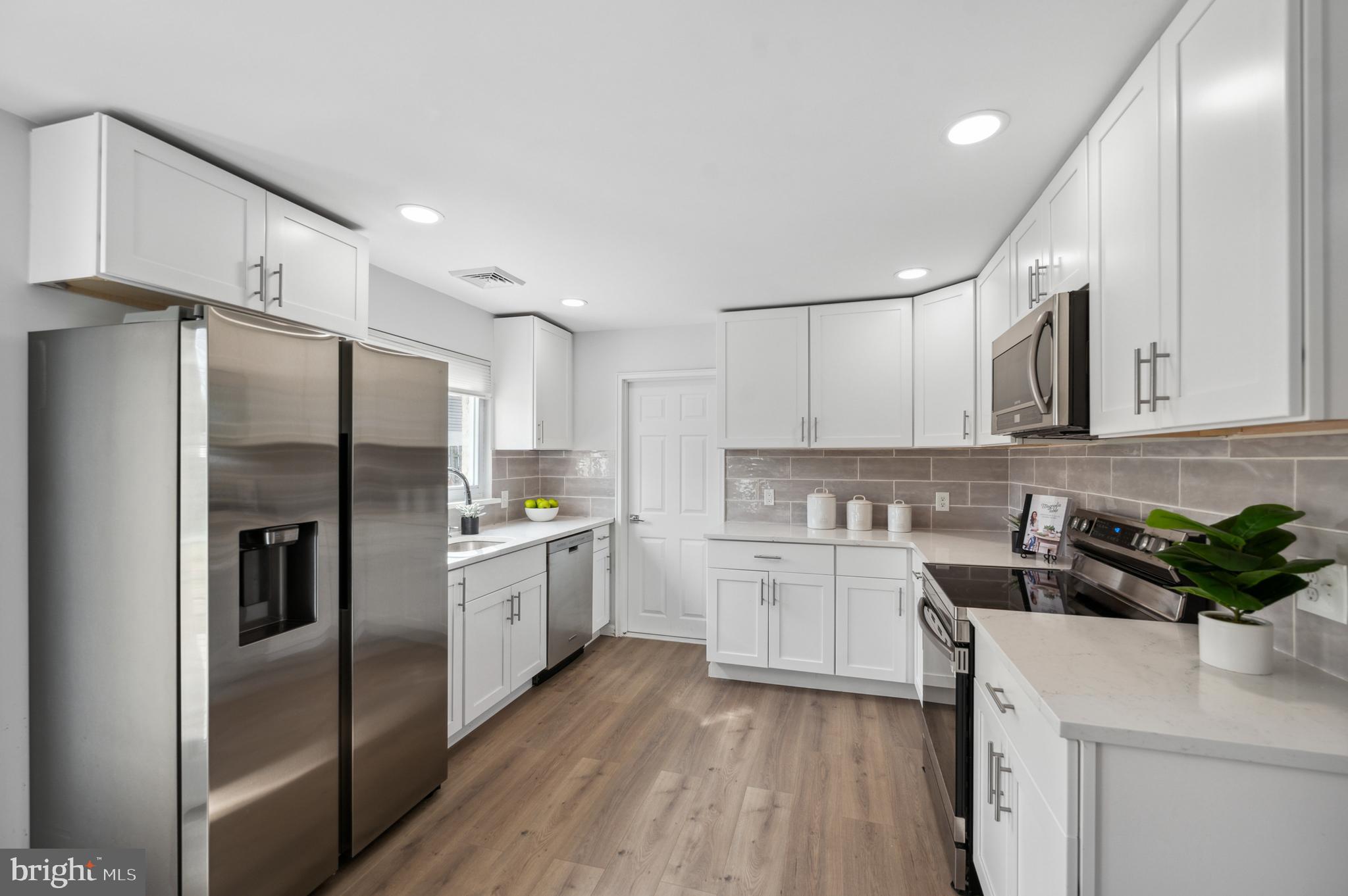 2210 Sproul Road Broomall, PA 19008 - Photo 4 of 26 a kitchen with a sink stainless steel appliances and cabinets