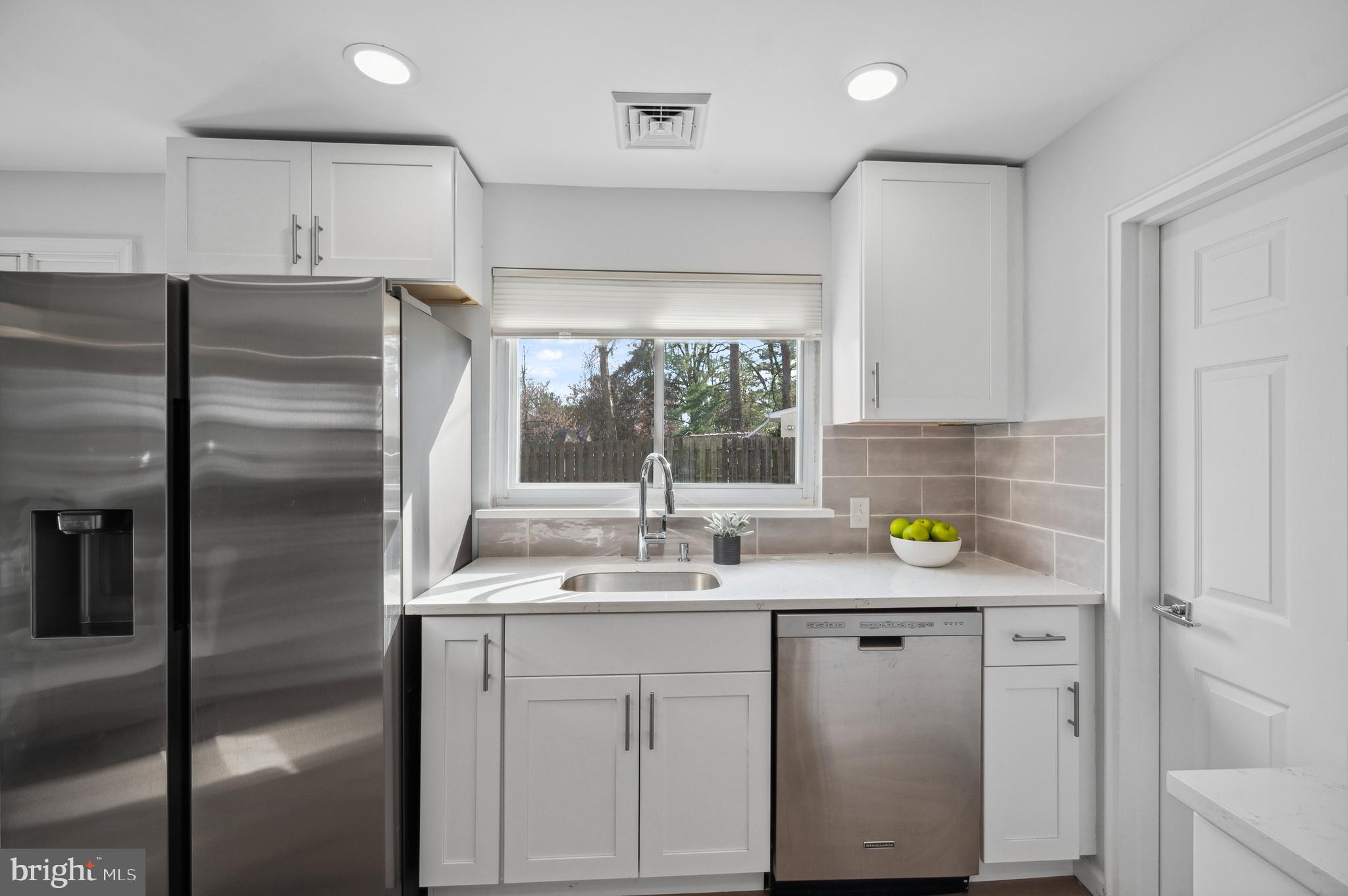 2210 Sproul Road Broomall, PA 19008 - Photo 5 of 26 a kitchen with kitchen island granite countertop stainless steel appliances a sink a counter space and window