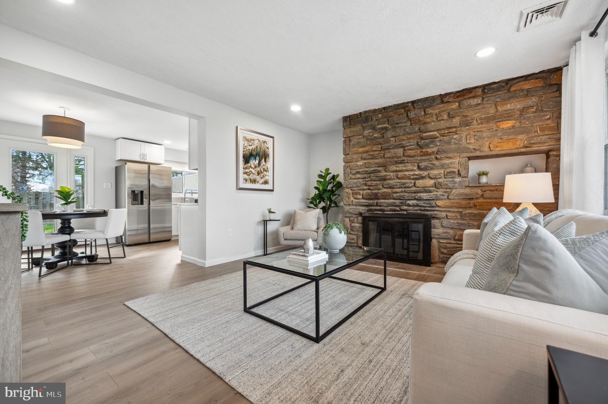 2210 Sproul Road Broomall, PA 19008 - Photo 8 of 26 a living room with furniture and a fireplace