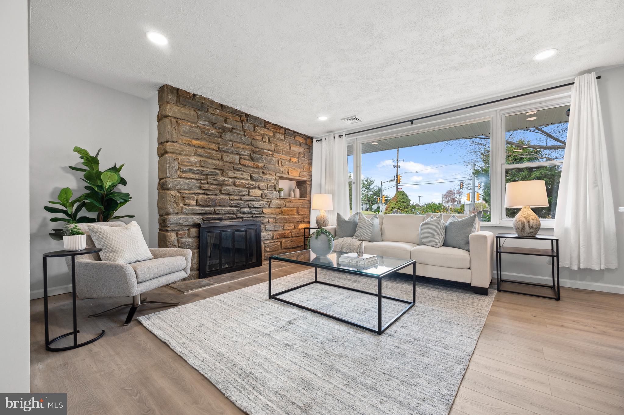 2210 Sproul Road Broomall, PA 19008 - Photo 9 of 26 a living room with furniture and a fireplace