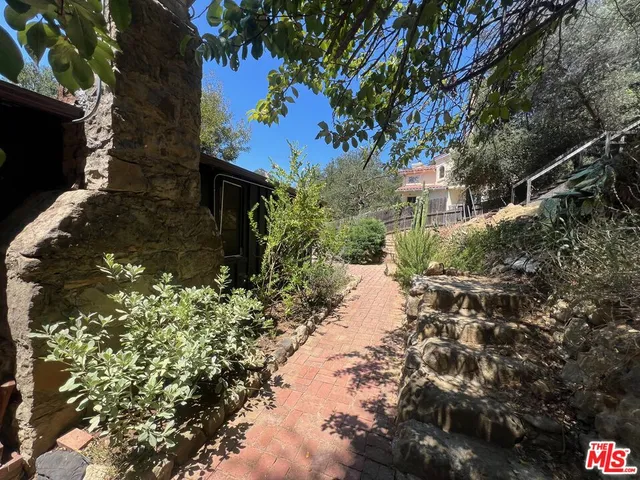 a backyard of a house with a yard and outdoor seating