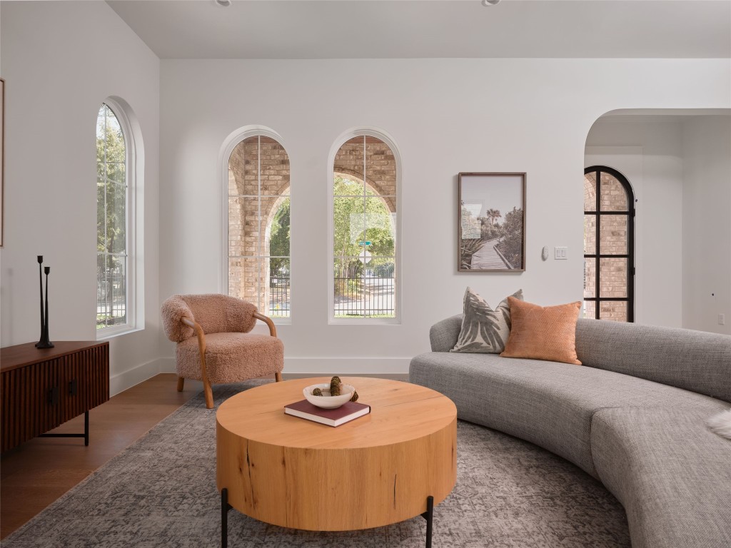 610 Allen Street, Unit 1 Austin, TX 78702 - Photo 11 of 32 Living area featuring arched walkways and wood finished floors