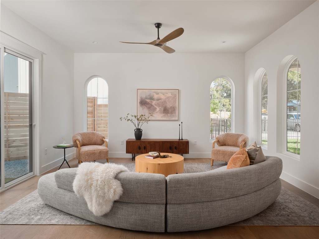 610 Allen Street, Unit 1 Austin, TX 78702 - Photo 12 of 32 Living area featuring a ceiling fan, healthy amount of natural light, and wood finished floors