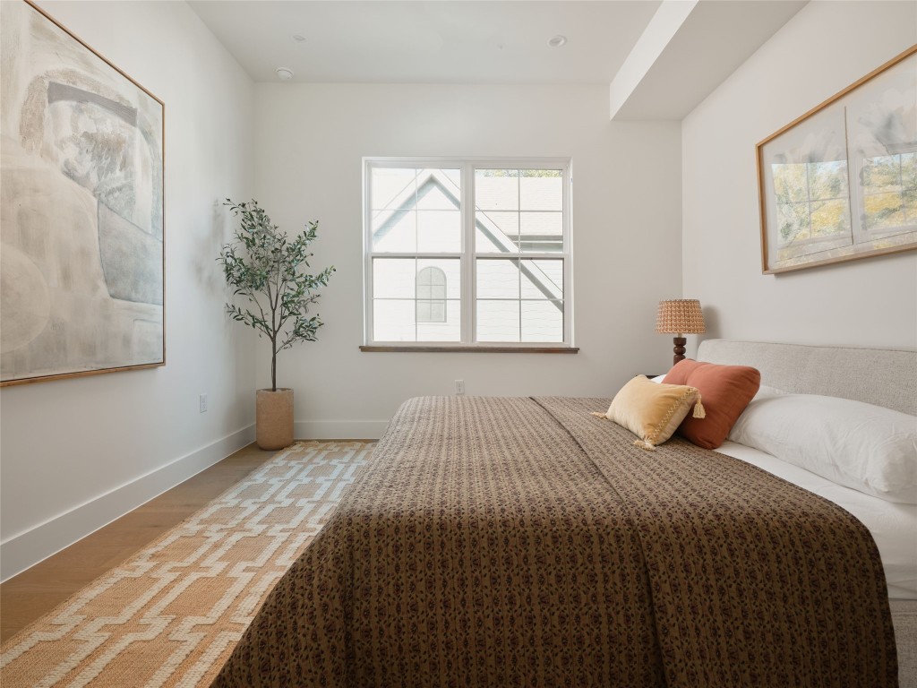 610 Allen Street, Unit 1 Austin, TX 78702 - Photo 16 of 32 Bedroom with baseboards and light wood-style flooring
