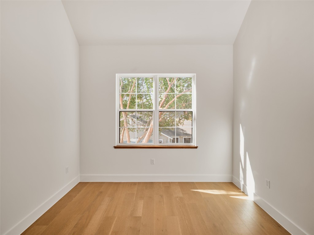 610 Allen Street, Unit 1 Austin, TX 78702 - Photo 28 of 32 Unfurnished room with light wood-style flooring and baseboards