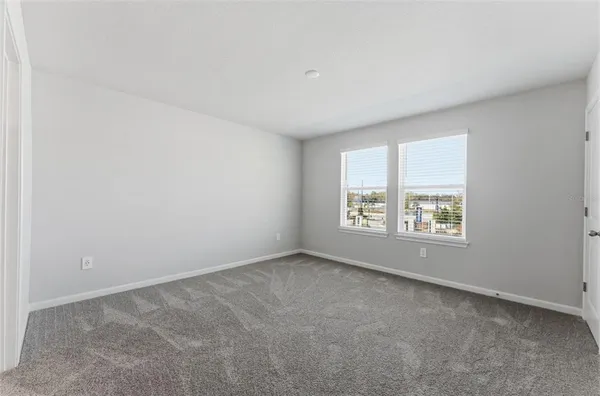a view of an empty room and closet area