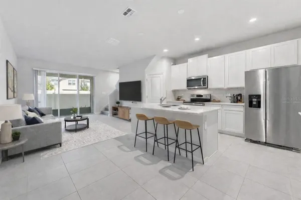 a kitchen with cabinets and stainless steel appliances