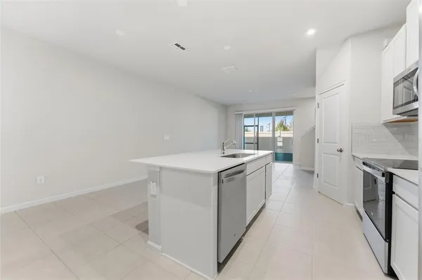a view of kitchen with furniture and refrigerator