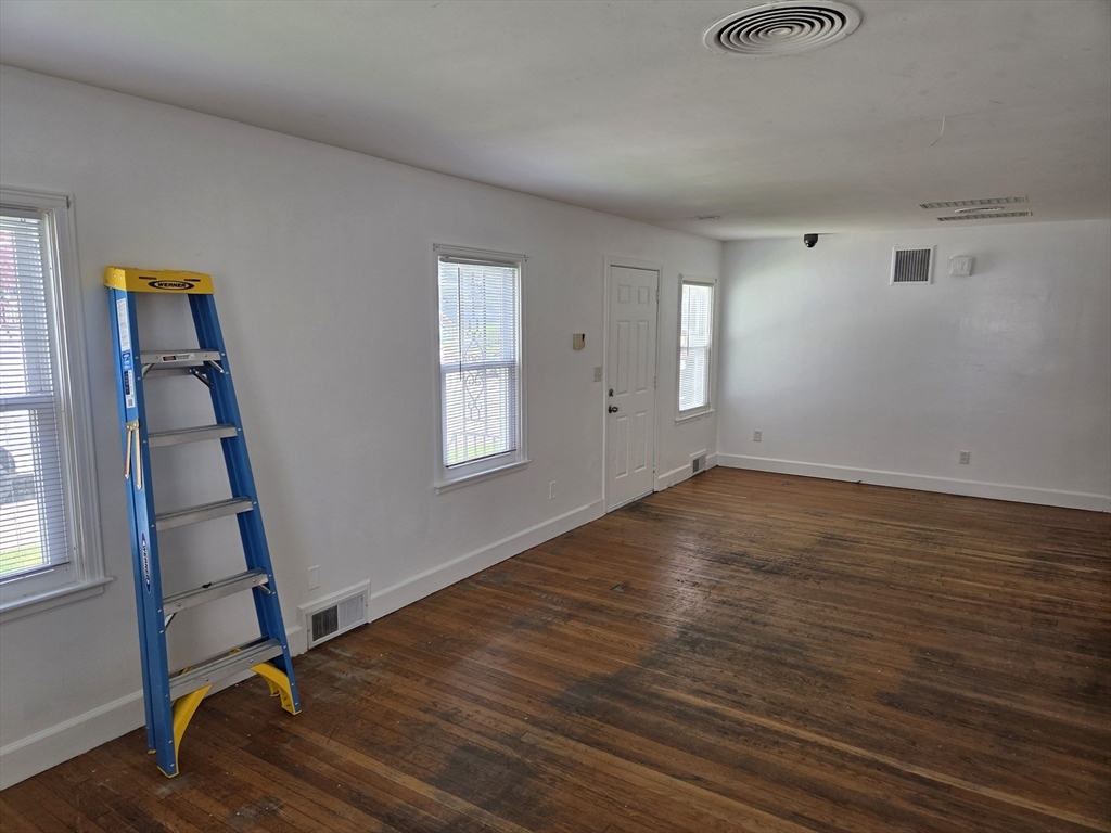 499 Maple Street Fall River, MA 02720 - Photo 9 of 21 an empty room with wooden floor and windows