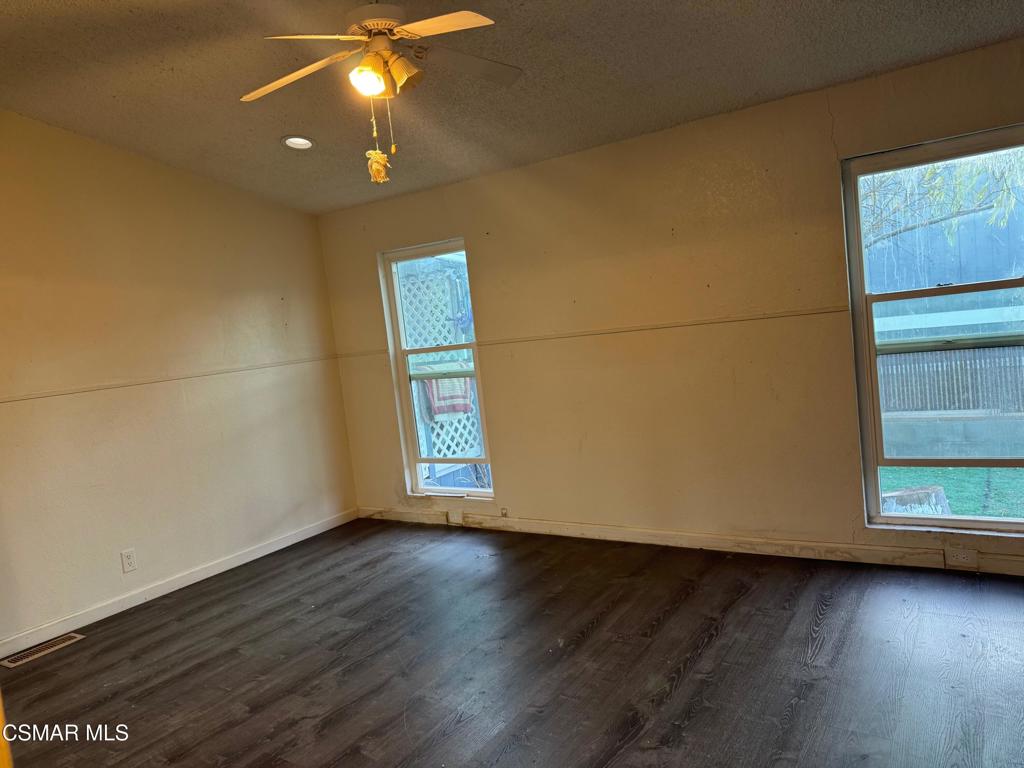 40701 Rancho Vista Boulevard, Unit 76 Palmdale, CA 93551 - Photo 16 of 31 an empty room with wooden floor and windows