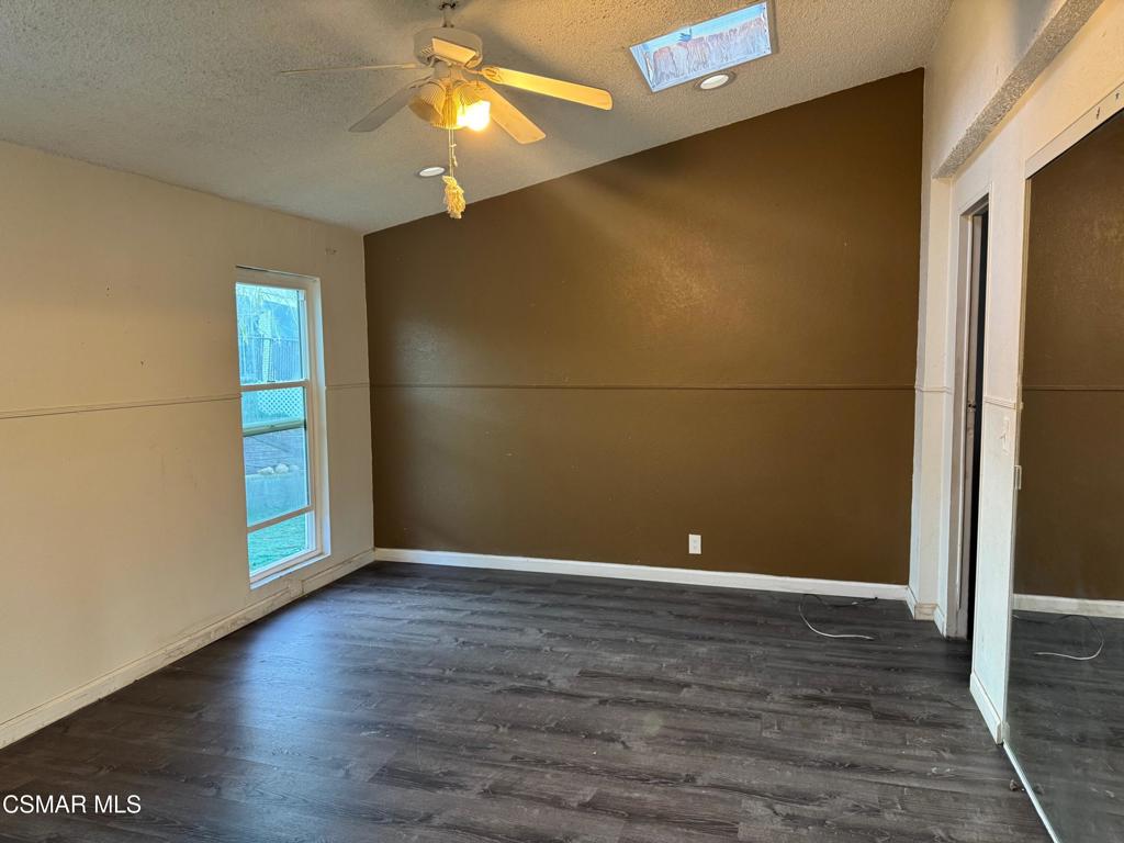 40701 Rancho Vista Boulevard, Unit 76 Palmdale, CA 93551 - Photo 17 of 31 a view of an empty room with window and wooden floor