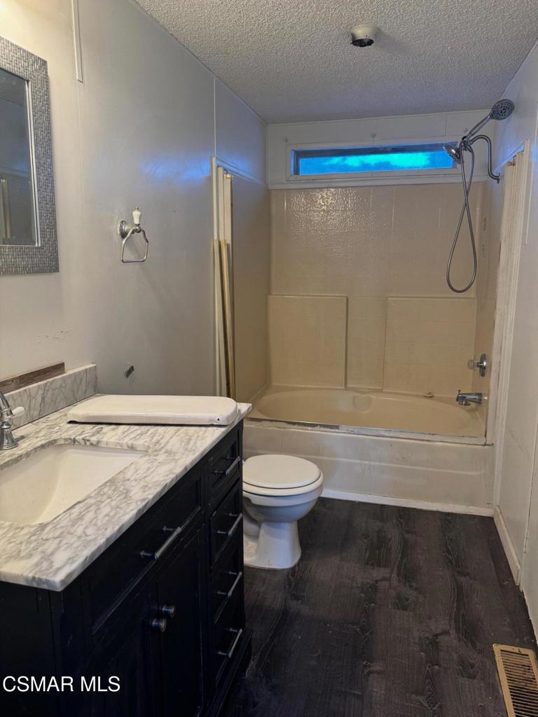 40701 Rancho Vista Boulevard, Unit 76 Palmdale, CA 93551 - Photo 18 of 31 a bathroom with a granite countertop sink toilet and shower