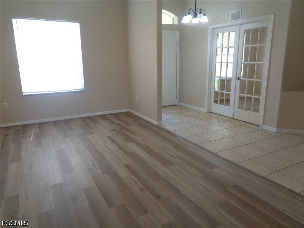 2463 Nature Pointe Loop Fort Myers, FL 33905 - Photo 5 of 50 an empty room with wooden floor and windows
