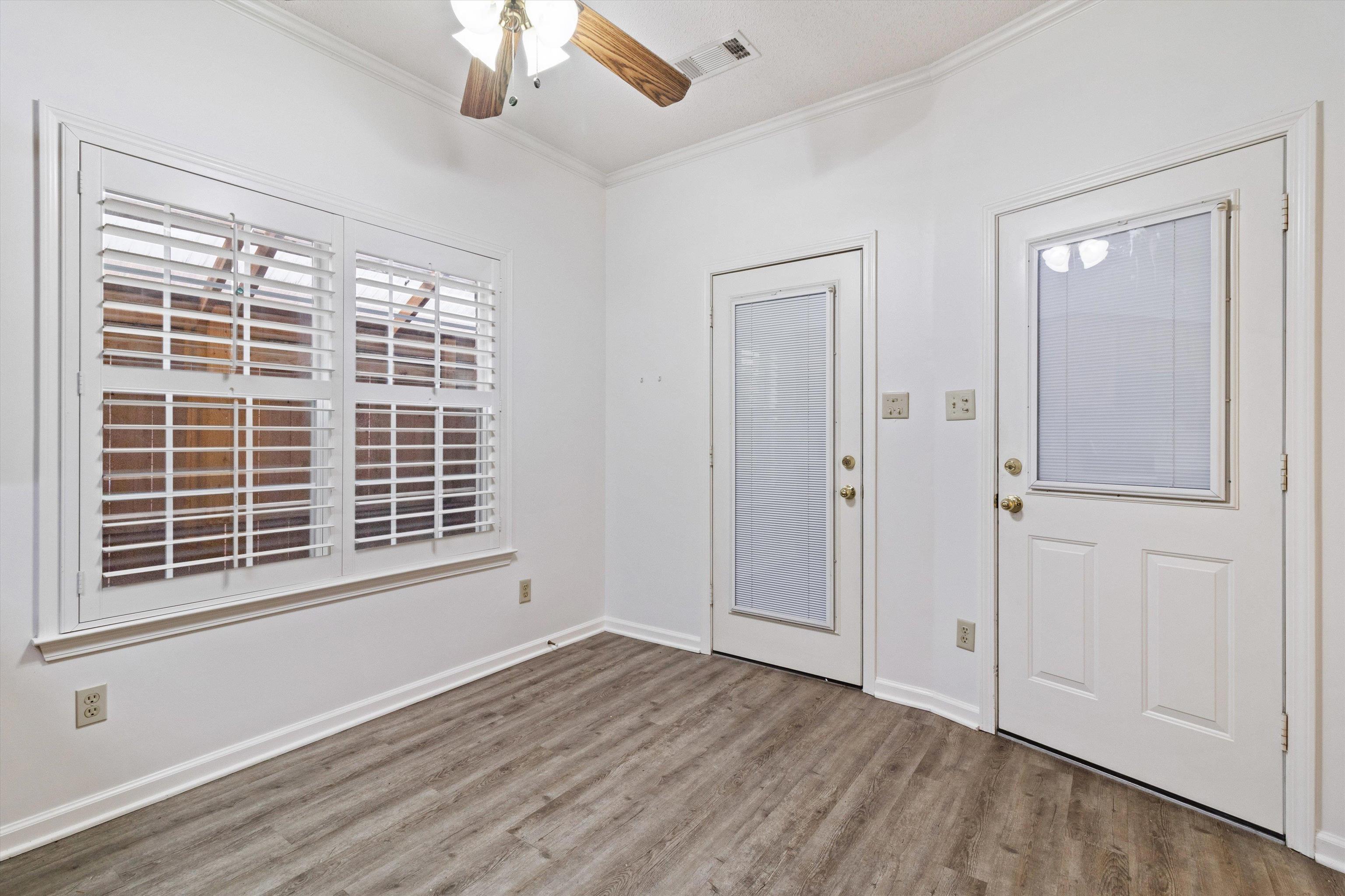 1262 South Collierville Arlington Road Collierville, TN 38017 - Photo 11 of 26 a view of empty room with wooden floor and fan