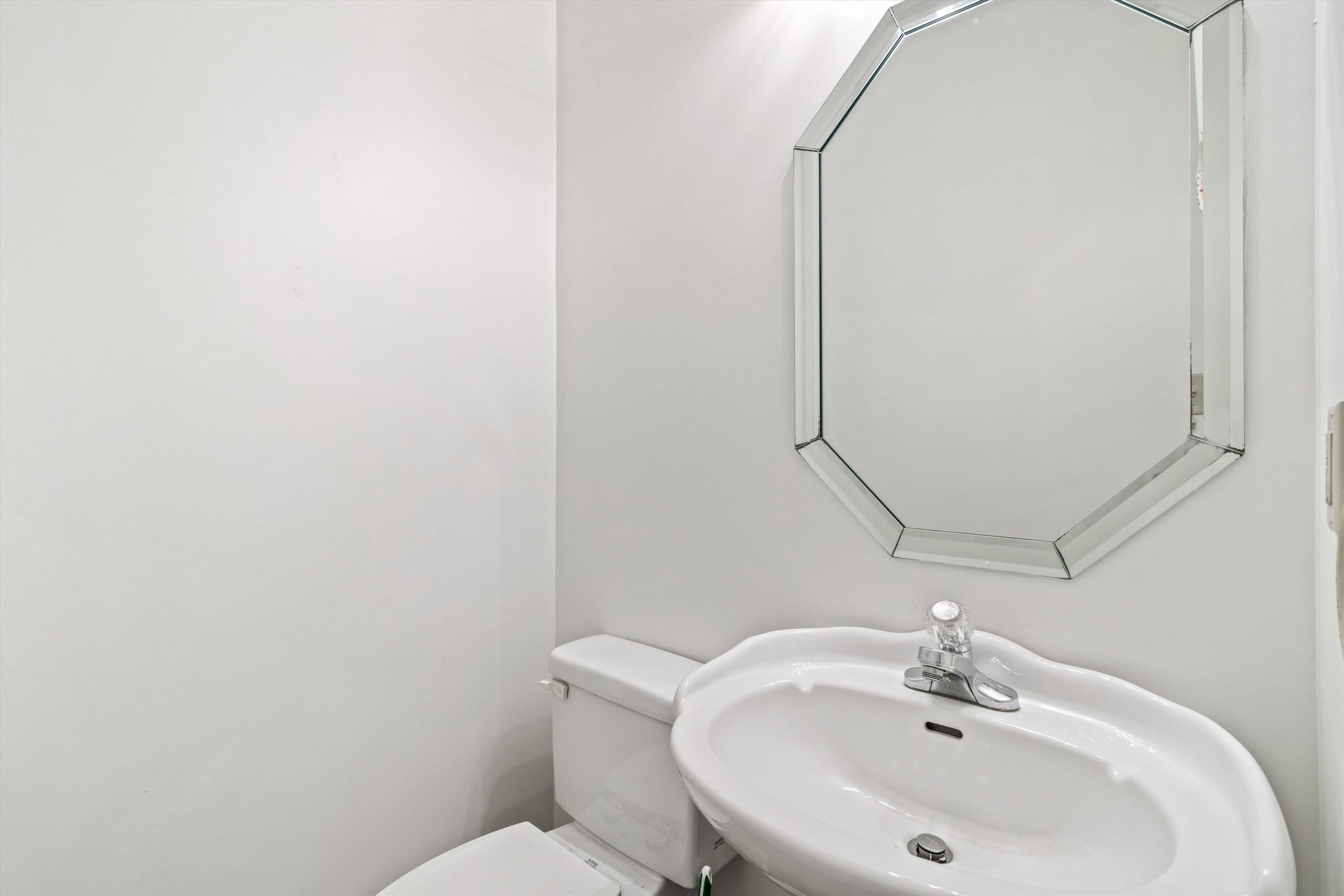 1262 South Collierville Arlington Road Collierville, TN 38017 - Photo 14 of 26 a bathroom with a sink a toilet and mirror