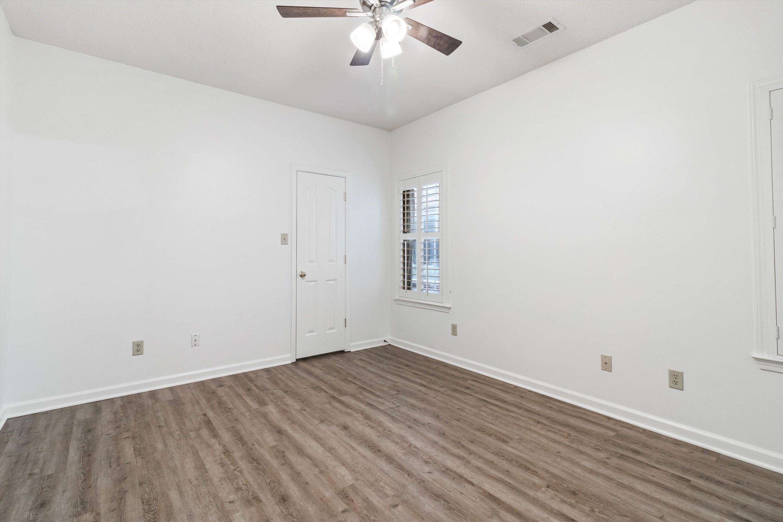 1262 South Collierville Arlington Road Collierville, TN 38017 - Photo 15 of 26 wooden floor in an empty room with a window