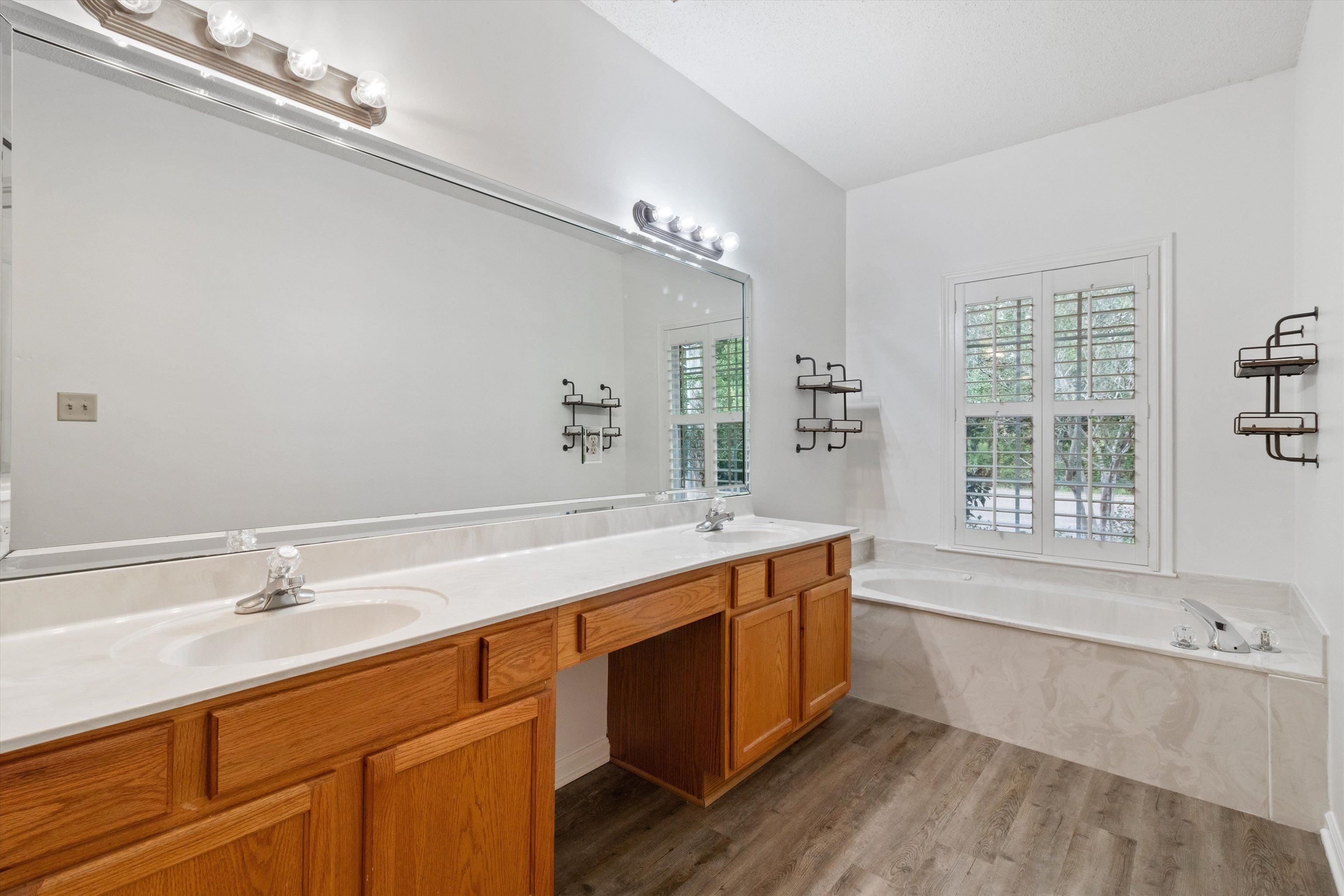 1262 South Collierville Arlington Road Collierville, TN 38017 - Photo 17 of 26 a bathroom with a tub sink and mirror