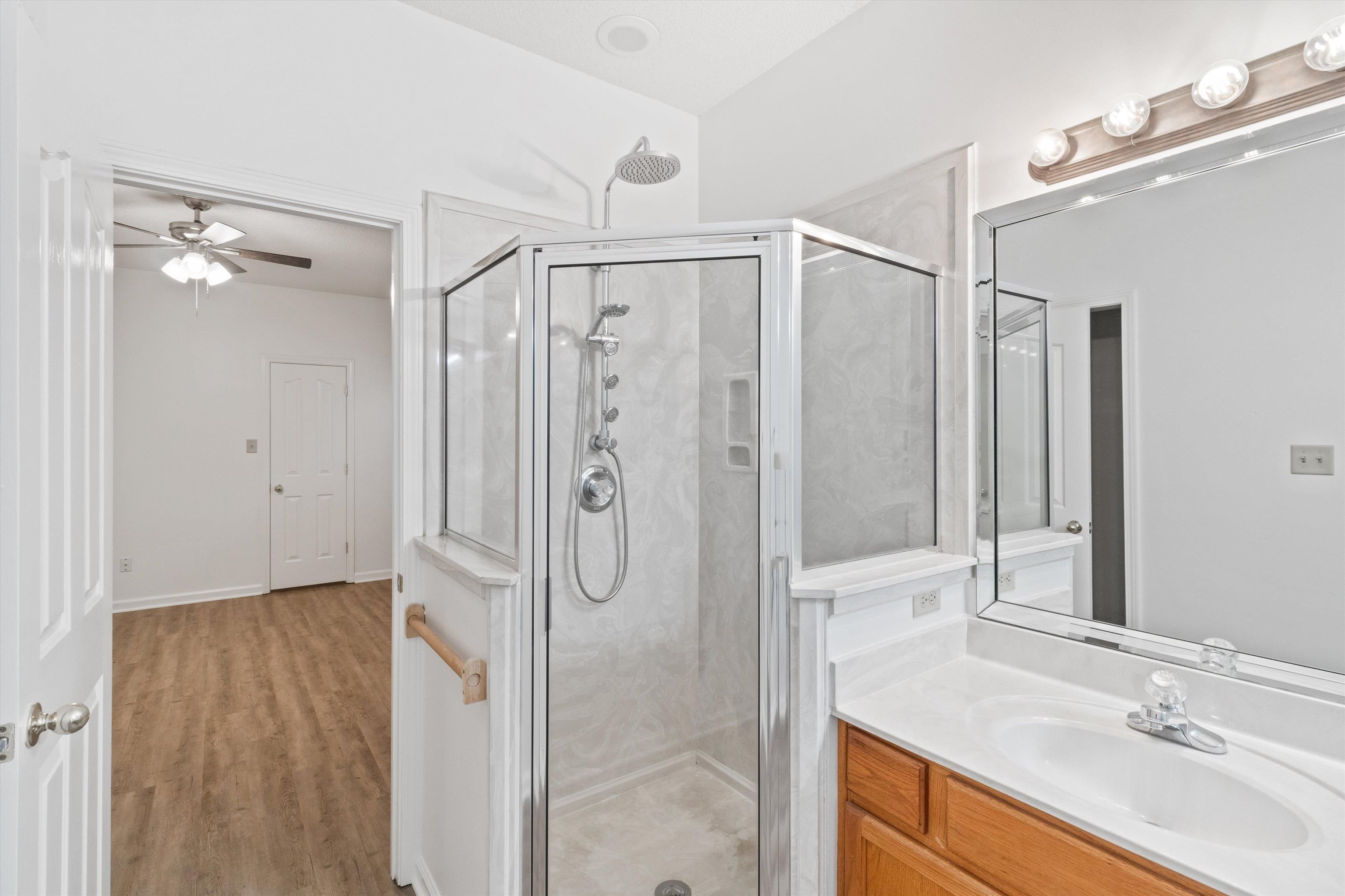 1262 South Collierville Arlington Road Collierville, TN 38017 - Photo 18 of 26 a bathroom with a shower sink and mirror