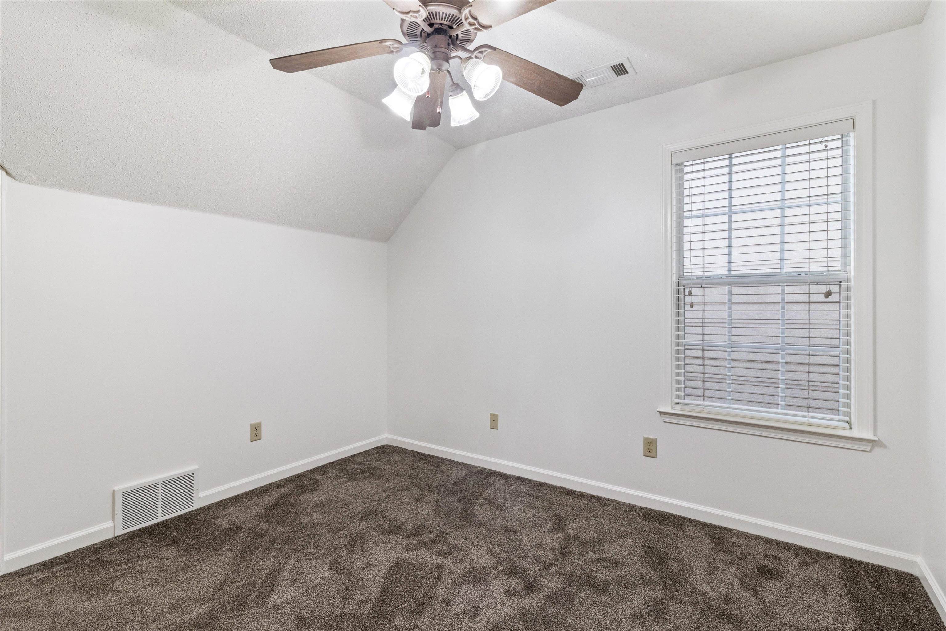 1262 South Collierville Arlington Road Collierville, TN 38017 - Photo 21 of 26 an empty room with a window and a fan