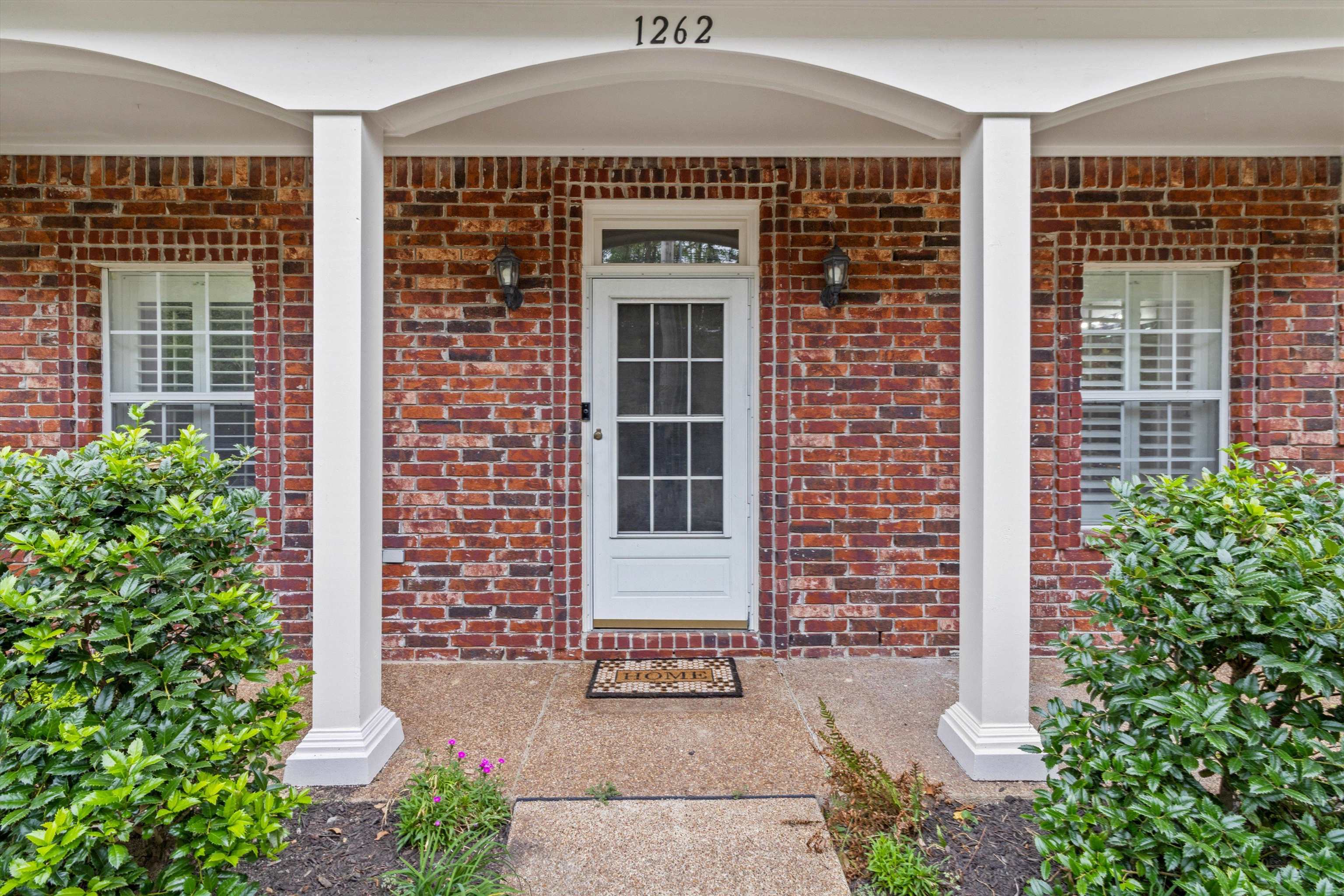 1262 South Collierville Arlington Road Collierville, TN 38017 - Photo 3 of 26 front view of a brick house with a large window