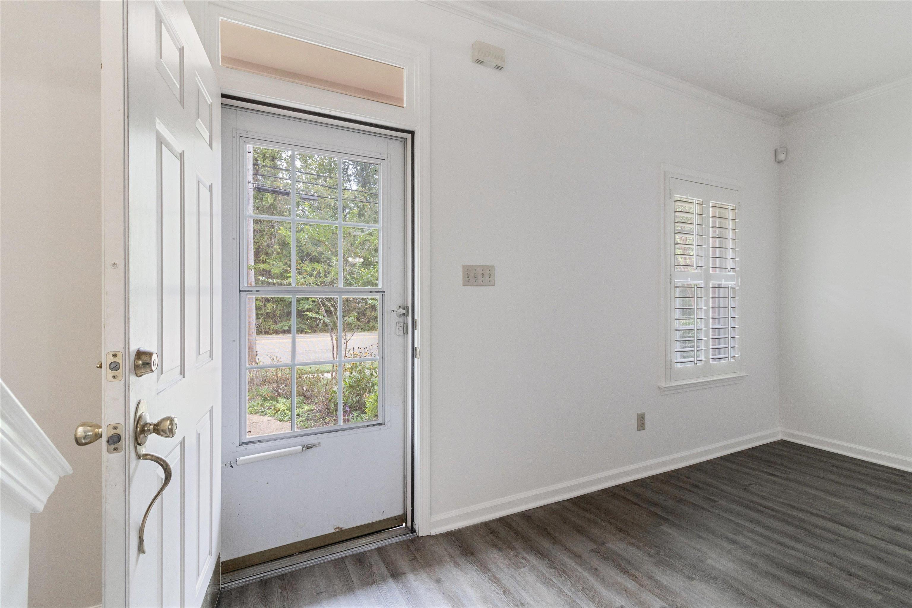 1262 South Collierville Arlington Road Collierville, TN 38017 - Photo 4 of 26 a view of an empty room with wooden floor and a window