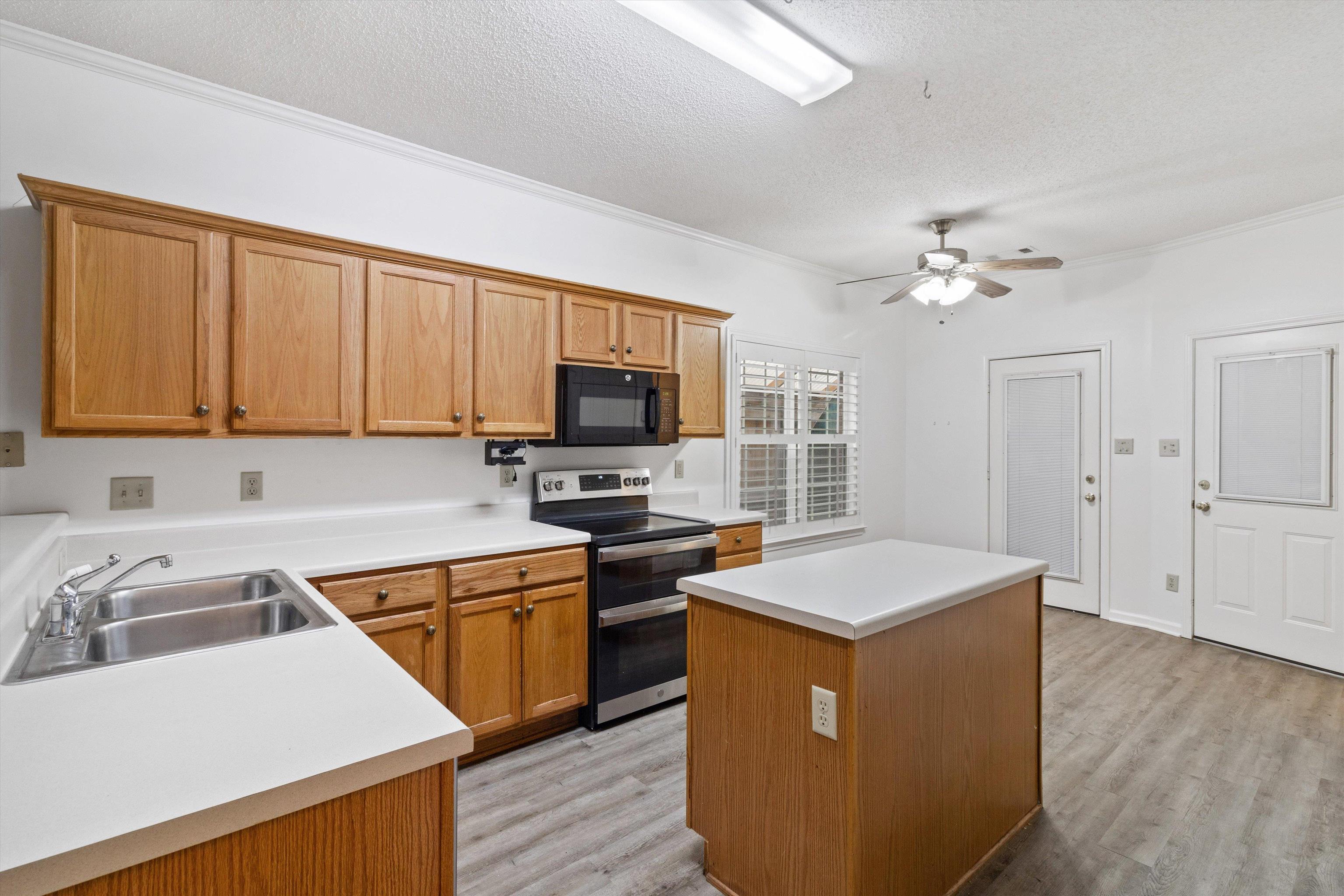 1262 South Collierville Arlington Road Collierville, TN 38017 - Photo 9 of 26 a kitchen with a sink appliances and cabinets