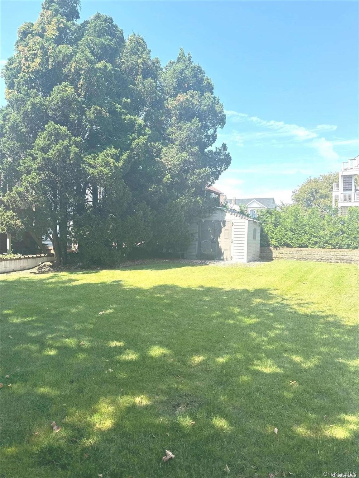 89 Lynbrook Avenue Point Lookout, NY 11569 - Photo 19 of 19 a view of yard with swimming pool and green space