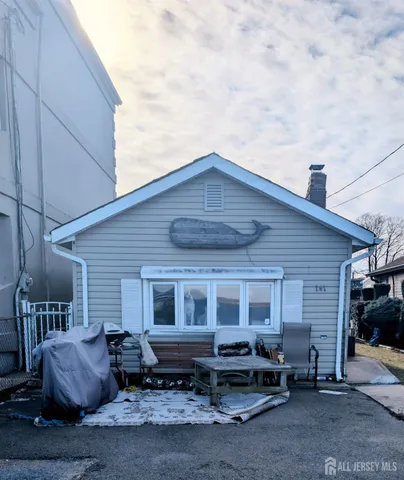 a front view of a house with sitting area