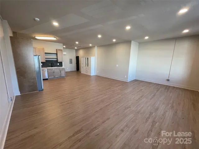 a view of kitchen with refrigerator and microwave