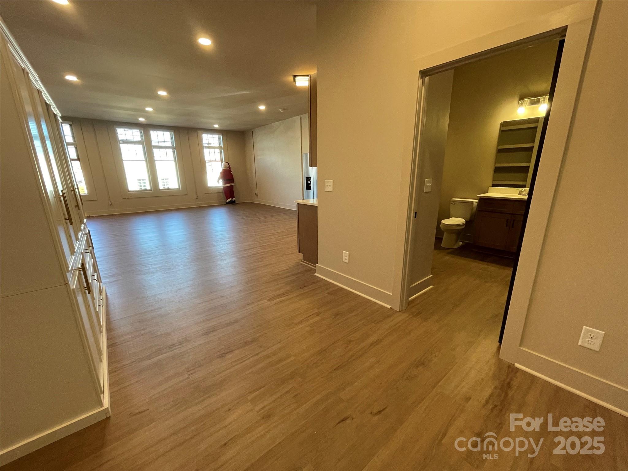 233 West Main Street, Unit A Albemarle, NC 28001 - Photo 7 of 10 a view of a hallway with wooden floor and windows