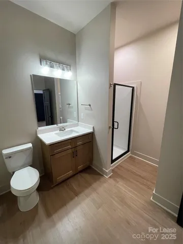a bathroom with a glass door shower and a sink