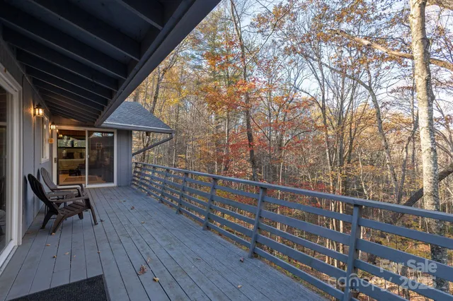 a view of a roof deck with wooden floor and fence
