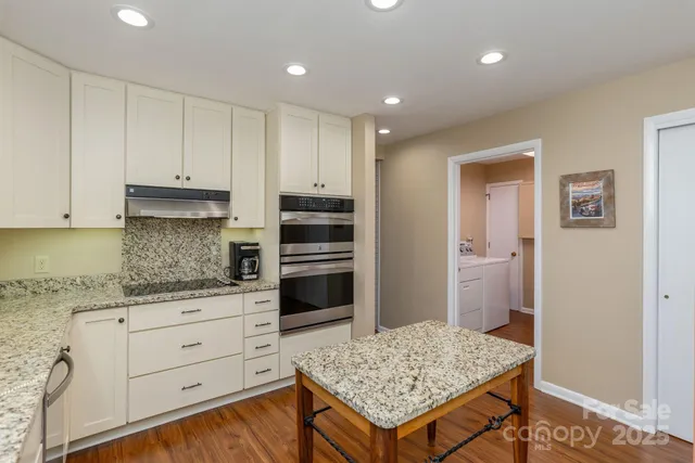 a kitchen with stainless steel appliances granite countertop a stove and refrigerator