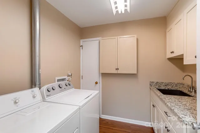 a view of washer and dryer with kitchen countertops