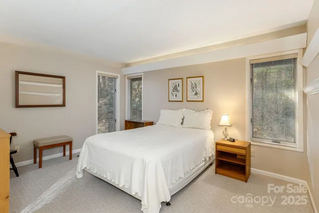 a bedroom with a bed and a lamp with table