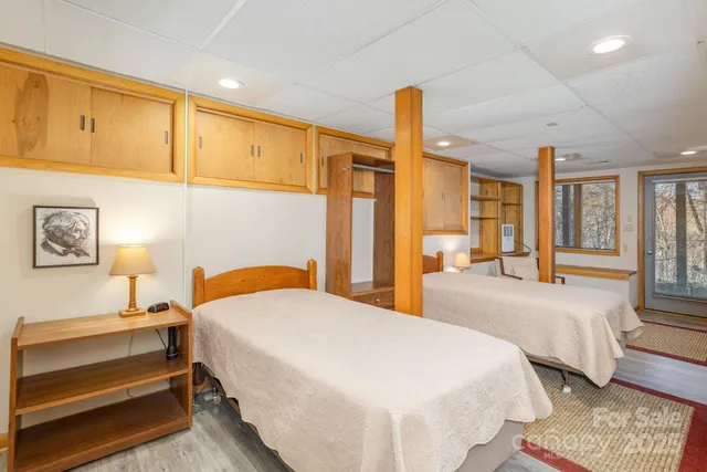 a bedroom with a bed a mirror and a window