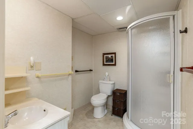 a bathroom with a toilet a sink and shower
