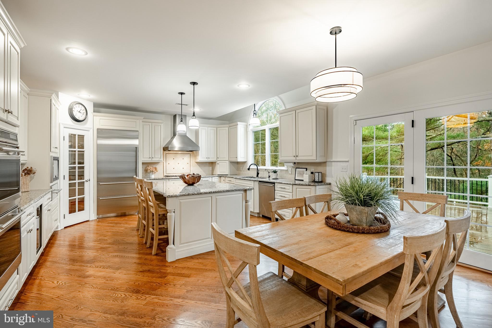 4 Amanda Lane West Chester, PA 19380 - Photo 21 of 108 a kitchen with stainless steel appliances kitchen island granite countertop a dining table chairs and granite counter tops