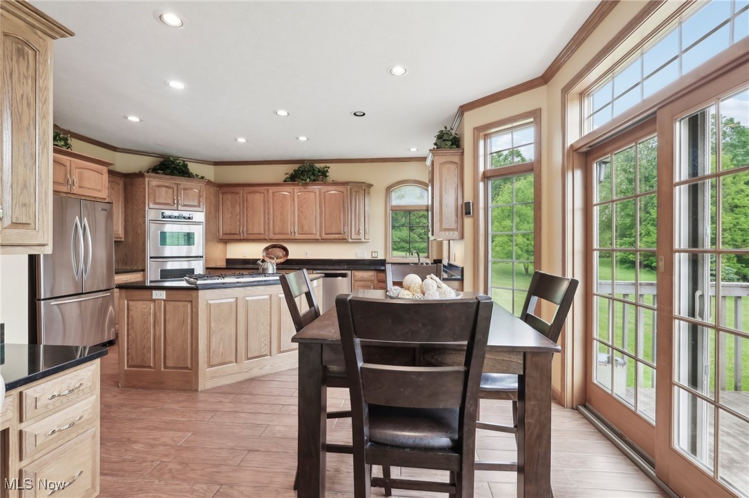 1491 Ridgewood Road Wadsworth, OH 44281 - Photo 11 of 36 Dining space featuring crown molding and recessed lighting and floor to ceiling windows.