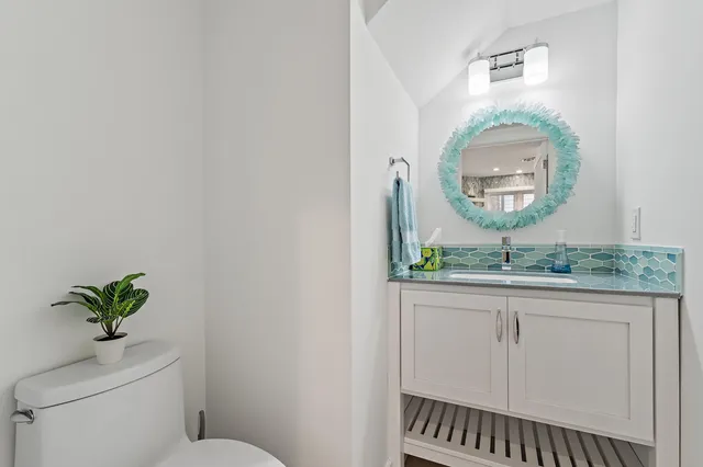a view of a room with wooden floor and a potted plant