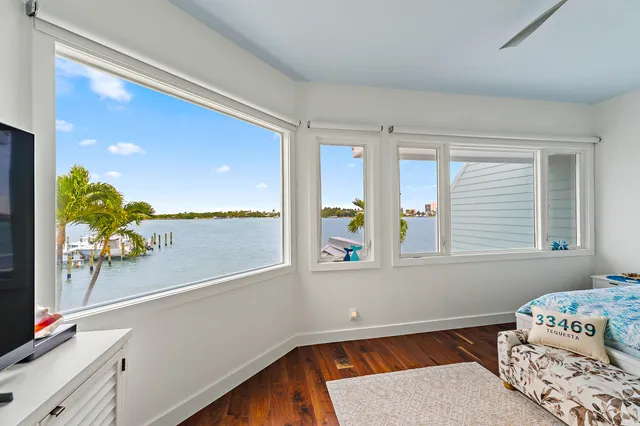 a bathroom with a granite countertop sink two mirror and shower