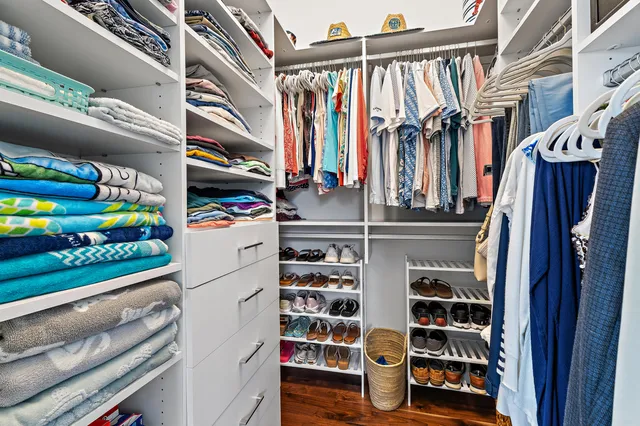 a bedroom with two beds and a painting on the wall