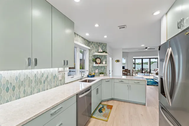 a kitchen with a sink stainless steel appliances and cabinets