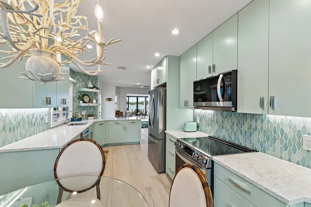 a kitchen with a stove a sink and a microwave