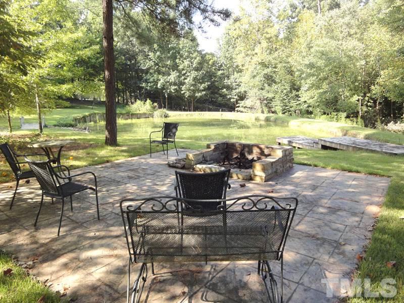 11932 Soco Court Raleigh, NC 27614 - Photo 22 of 25 a view of a lake with table and chairs